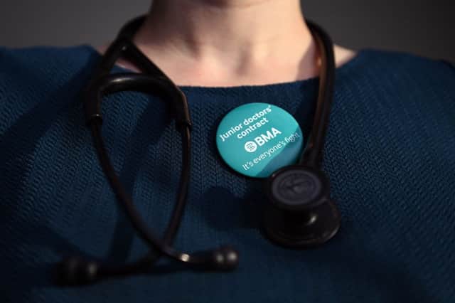 A doctor wearing a badge  in support of the junior doctor's contract, as talks aimed at averting strikes have resumed  Photo : Andrew Matthews/PA Wire