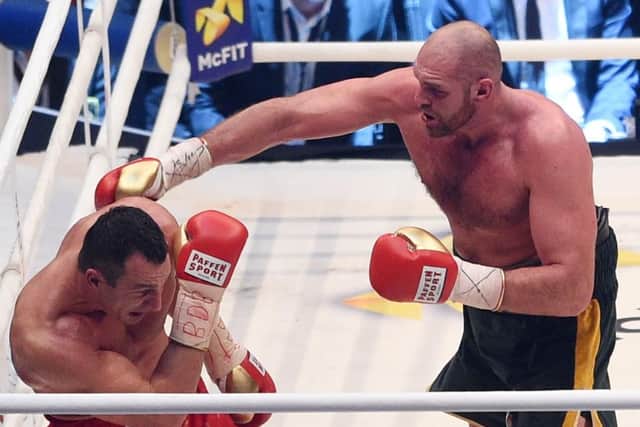 Ukraine's Wladimir Klitschko, left, tries to fend off an attack from Britain's Tyson Fury (Picture: Sebastian Konopka/AP).
