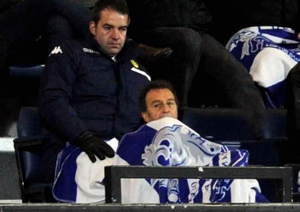 Leeds United chairman Massimo Cellino attempts to keep warm with a QPR blanket wrapped around him as he watches the defeat at Loftus Road (Picture: James Hardisty).