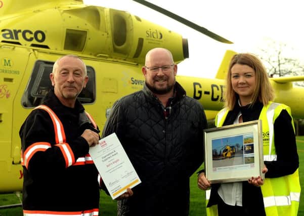 Mark Larkin is presented with an award by Andy Hall, YAA pilot, and Kerry Garner.