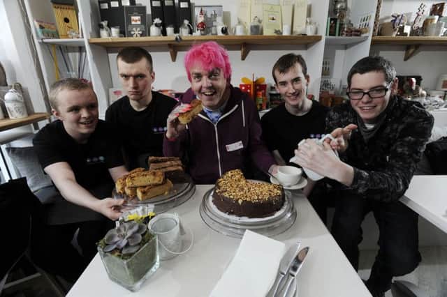 Alan Gardner is served tea and cakes by trainees, (l-r) Dalton Ewen,  17, Patrick Samson, 19,  Jack Harris, 20,  and Ross Hall 20, as he opens the Lighthouse & Union Store in Otley Road, Cookridge . Picture Bruce Rollinson