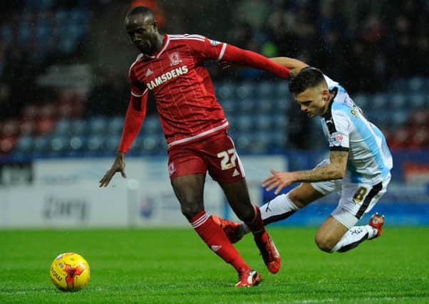 Huddersfield's Jamie Patterson falls under pressure from Middlesbrough's Albert Adomah. .  Picture: Bruce Rollinson