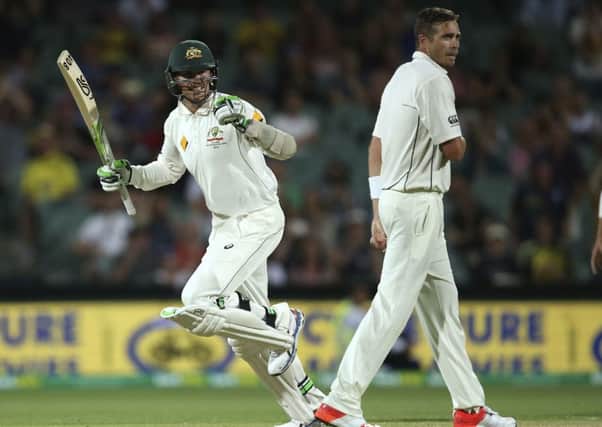 Australia's Peter Siddle, left, celebrates hitting the winning runs as he passes New Zealand's Tim Southee Picture: AP.