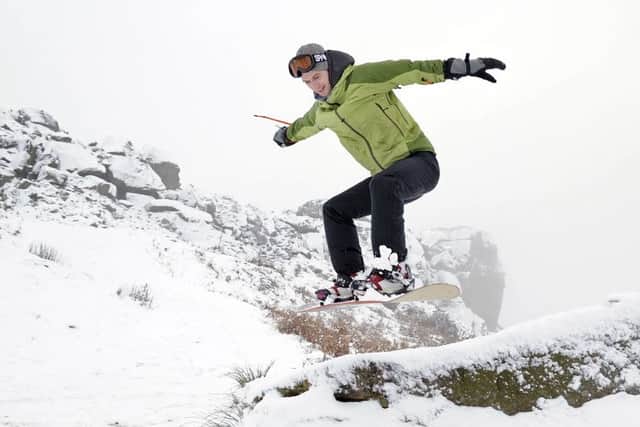 Snowboarder Oliver Barnes enjoying the fresh snow at the Cow and Calf rockas above Ilkley in December 2010.

Picture Bruce Rollinson
