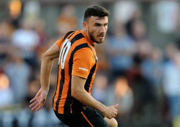 Robert Snodgrass is pictured playing a pre-season friendly for Hull against York City on July 23, 2014, just weeks after joining the club from Norwich City for £7m, and a few days before he would dislocate his kneecap on the opening day of last season. Sixteen months later he finally made his first-team return at Manchester City on Tuiesday night, and now hopes to face former club Leeds on Saturday. (Picture: Nigel French/PA Wire)