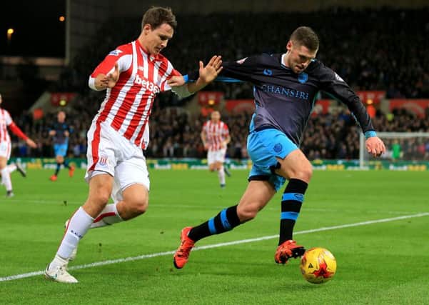 Stoke City's Philipp Wollscheid (left) and Sheffield Wednesday's Gary Hooper in action during to the Capital One Cup, Quarter Final (Picture: Nigel French/PA Wire).