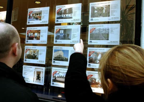 File photo of a young couple studying property for sale in an estate agent's window. PRESS ASSOCIATION Photo. Issue date: Monday December 26, 2011. Houses bought by first-time buyers in November were found to be priced at 'affordable' levels in 44% of local authority districts in the UK, the highest proportion for eight years, the First-Time Buyer Review found. See PA story MONEY First. Photo credit should read: John Stillwell/PA Wire