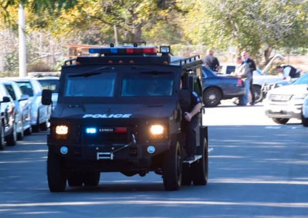 A swat team arrives at the scene of a shooting in San Bernardino, Calif., on Wednesday,  Dec. 2, 2015.  Police responded to reports of an active shooter at a social services facility. (Doug Saunders/Los Angeles News Group via AP) MANDATORY CREDIT