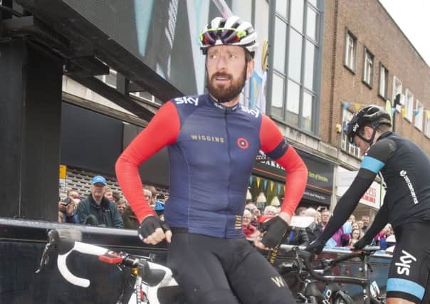 Sir Bradley Wiggins takes timeout before the start of a stage of the Tour de Yorkshire