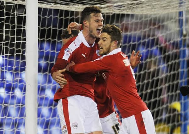 Sam Winnall, right, celebrates with Kevin Long after his Barnsley team-mate scored the winner at Oldham earlier this month (Picture: Steve Riding).