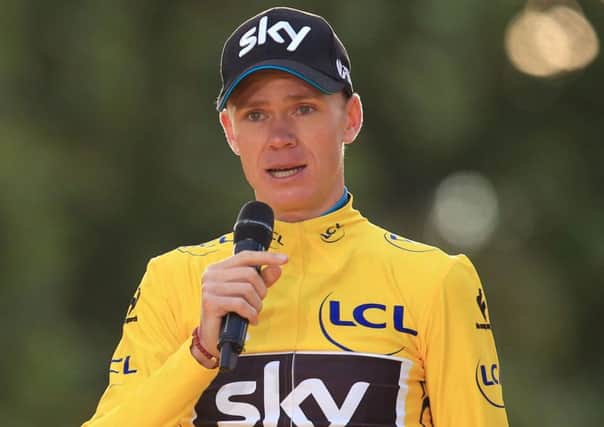 Team Sky's Chris Froome makes a speech as he celebrates winning the 2015 Tour de France
