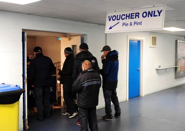 Voucher holders queue for their pie and pint at Elland Road on Saturday.