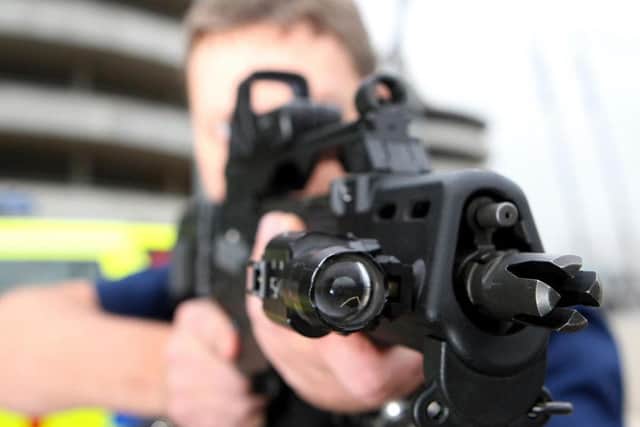 An armed police officer. Photo: PA.