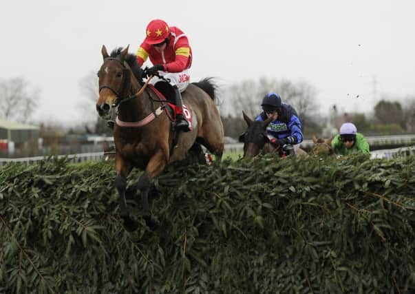 Highland Lodge and Henry Brooke jump the final fence as they win the Betfred Becher Chase.