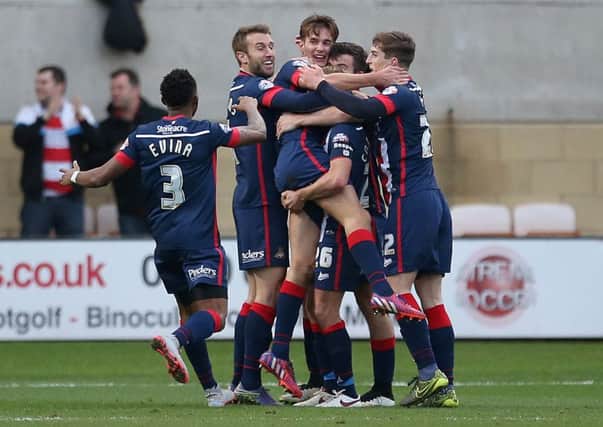 Doncaster Rovers' Mitchell Lund, centre, celebrates scoring his side's second goal against Cambridge United (Picture: Steve Paston/PA Wire).
