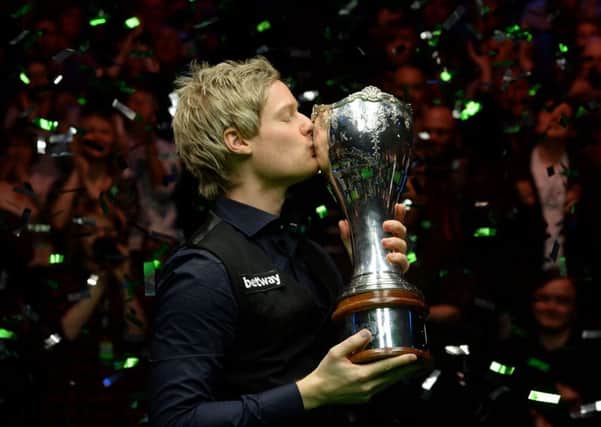 Neil Robertson celebrates with the trophy after winningUK Championship in York.