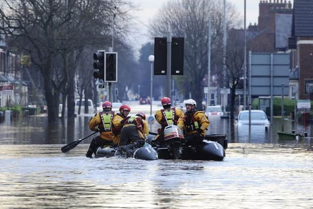 Fire and Rescue teams bring people out of flooded homes in Carlisle following heavy rains over he weekend.