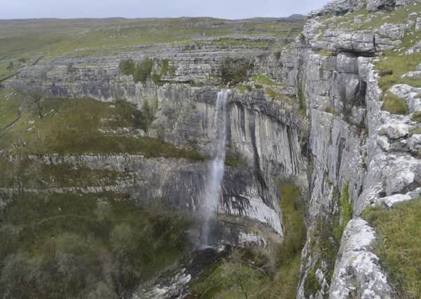 Water falls over the cliffs at Malham Cove, North Yorkshire, for the first time in a hundred years  following heavy rain in the area. Picture: Jim Sputnik/PA Wire