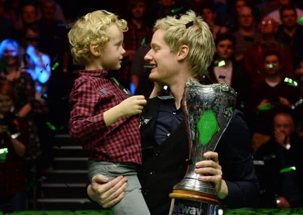 Neil Robertson celebrates with the trophy and his son Alexander.