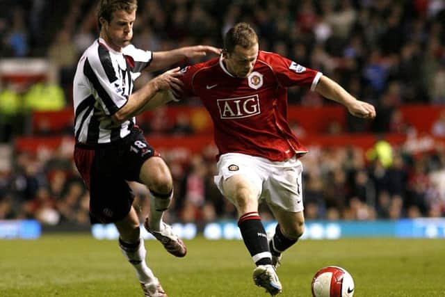 Manchester United's Wayne Rooney (right) and Sheffield United's Michael Tonge battle for the ball duri ng nthe last meeting between the two sides at Old Trafford back in 2007.