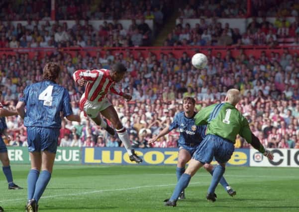 Brian Deane, scoring the first-ever Premiership goal for Sheffield United v Manchester United at Bramall Lane in August 1992.