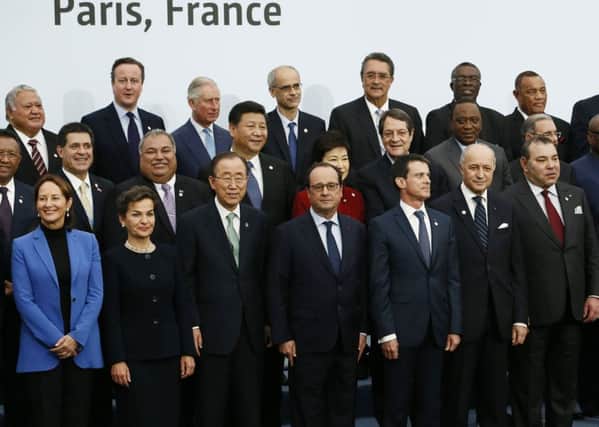 French President Francois Hollande, front centre, poses with world leaders for a group photo as part of the COP21, United Nations Climate Change Conference, in Le Bourget, outside Paris.