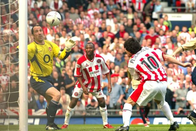 Arsenal's David Seaman makes a finger tip save from a header by Sheffield United's Paul Peschisolido, during their FA Cup semi-final match at Old Trafford, on April 13, 2003 (PA photo)