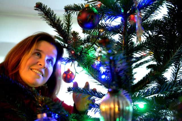 Cathryn Fawcett decorating her  christmas tree.