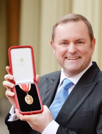 Sir Gary Verity holds his insignia of Knighthood which was presented by the Prince of Wales at the Investiture ceremony in Buckingham Palace, London.
