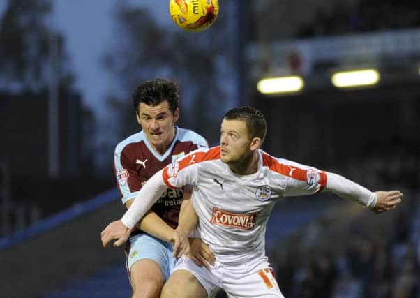 Harry Bunn challenges Joey Barton during Huddersfield Town's match with Burnley in October (Picture: Bruce Rollinson).
