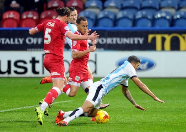 Huddersfield Town striker Nahki Wells is tripped by central defender Luke Ayling for a penalty which Emyr Huws failed to convert (Picture: James Hardisty).