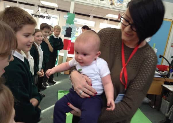 The Roots of Empathy programme at Green Top Primary, Doncaster. Baby Reuban with mum Charlotte and Year 4 pupils.
