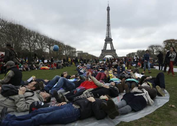 Activists stage a 'die -in' during a demonstration near the Eiffel Tower during the climate change summit.