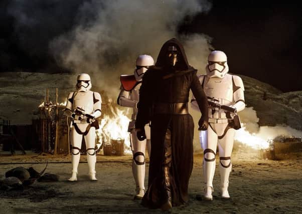Kylo Ren (Adam Driver) with the Stormtroopers in Star Wars: The Force Awakens.
