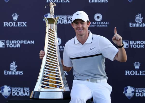 Rory McIlroy of Northern Ireland poses with the Race to Dubai trophy after he won the final round of DP World Tour Championship golf tournament in Dubai, United Arab Emirates. (AP Photo/Kamran Jebreili)