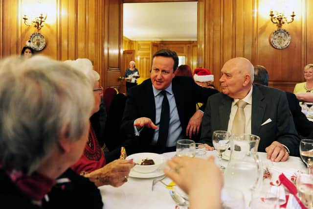 Prime Minister David Cameron sits down for a chat with Barry Fletcher, who attends the Friendship Lunches at the Durham Ox pub in Crayke, North Yorkshire.