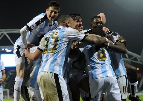 Huddersfield Town's players celebrate with Ishmael Miller after he scored the Terriers' second goal in a 2-0 win over Rotherham United.  Picture: Bruce Rollinson.