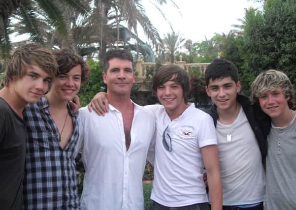 Louis Tomlinson, left, with Simon Cowell and fellow members of 1 Direction