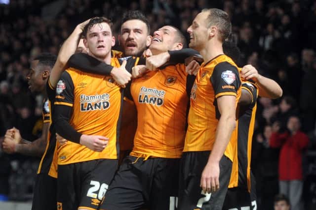 Jake Livermore, centre, is mobbed by his Hull City team-mates after scoring a late winner against Reading on Wednesday night. Picture: Tony Johnson.
