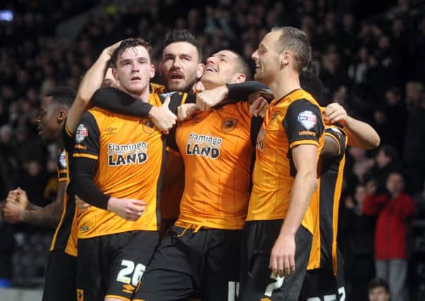 Jake Livermore, centre, is mobbed by his Hull City team-mates after scoring a late winner against Reading on Wednesday night. Picture: Tony Johnson.
