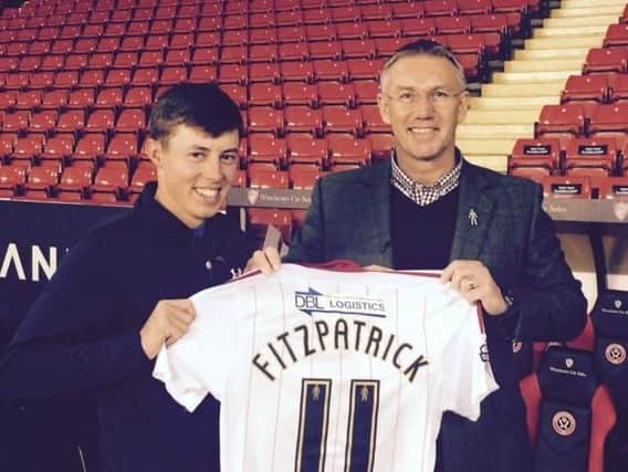 Matt Fitzpatrick is presented with a shirt bearing his name by Sheffield United's manager Nigel Adkins.