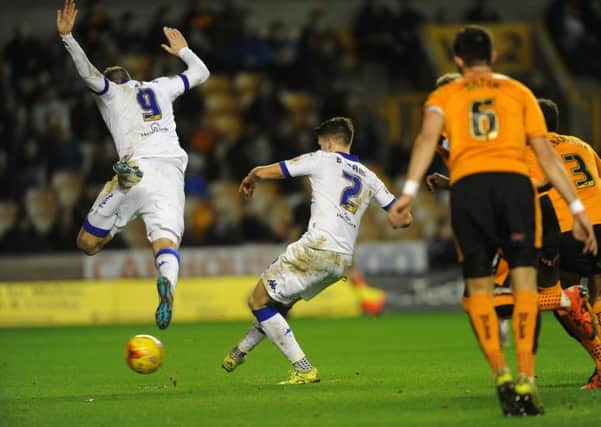 Chris Wood rises to leave the way clear for Sam Byram to slot home the first of his two goals that helped Leeds United beat Wolves 3-2 (Picture: Jonathan Gawthorpe).