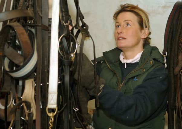 Jo Foster sorting out the tack at her stables.