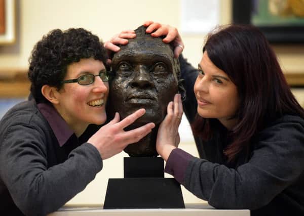 181215   Welcome Team Leaders Hannah Savage (left) and Julie Redpath  at York Art Gallery put their hands on a bronze sculpture by Jacob Epstien  (1890-1959), of the internationally  know actor and singer Paul Robeson made in 1927 in the 'hands on sculpture' gallery at York Art Gallery. (GL1008/39f)