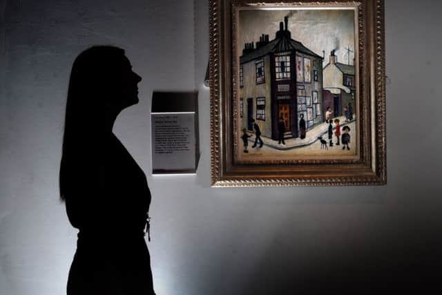 York Art Gallery opens..Curatorial Assistant Lorna Frost views the L S Lowry painting named Wilsons Terrace 1953, at the gallery ..SH10014195a.22nd July 2015 ..Picture by Simon Hulme
