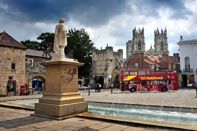 Statue to the artist William Etty outside York Art Gallery by Bootham Bar with The Minster towering overhead.  Picture Tony Johnson