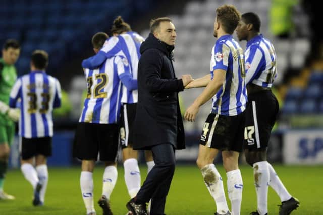 Owls head coach Carlos Carvalhal congratulates his players at the final whistle. Picture: Steve Ellis.