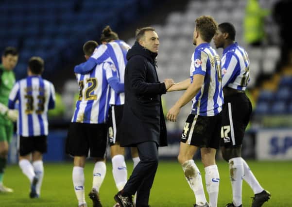 Owls head coach Carlos Carvalhal congratulates his players at the final whistle. Picture: Steve Ellis.