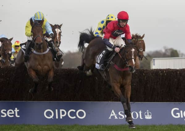 Wakanda, ridden by Danny Cook, left, trails Houblon Des Obeaux, ridden by Charlie Deutsch, over an early fence before going on to win the Sodexo Silver Cup Handicap Steeple Chase Race at Ascot (Picture: PA).