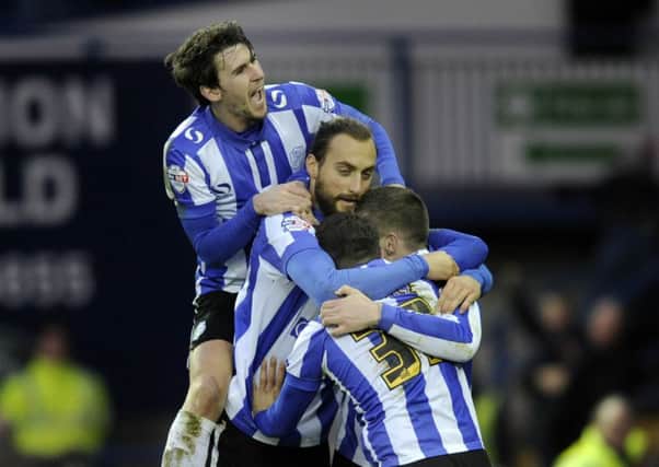 Gary Hooper is mobbed by Sheffield Wednesday team-mates after scoring their final goal in yesterdays 4-1 win over Wolverhampton Wanderers (Picture: Steve Ellis).